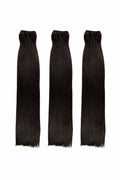 Three black hair extensions on a white background