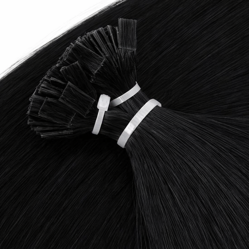 Close-up of black hair extensions with silver bands on a black background